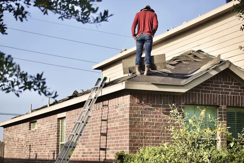 Professional roofer working on a residential roof in Pontoon Beach